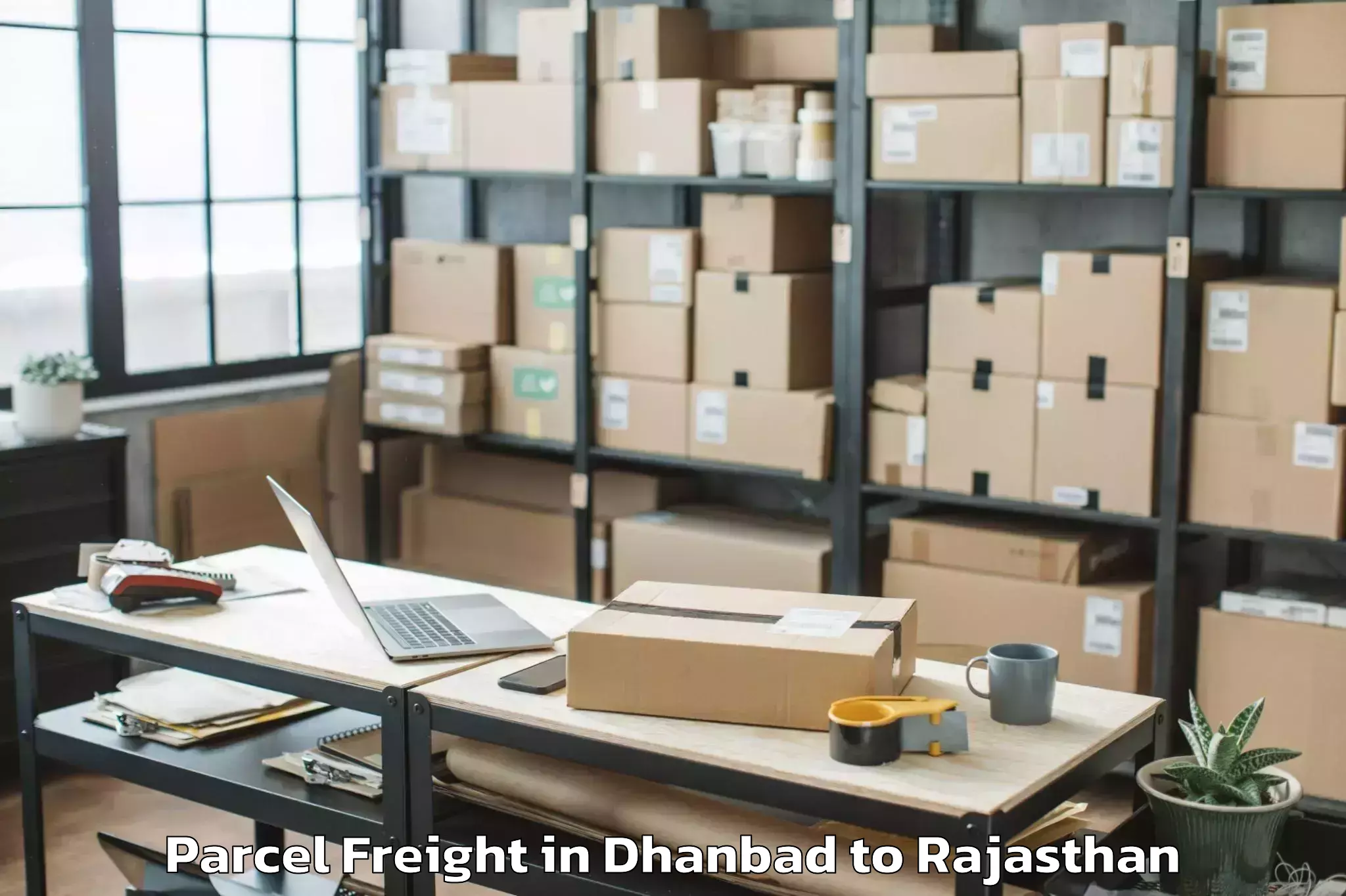 Easy Dhanbad to Sunrise University Alwar Parcel Freight Booking